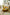 Living room with a yellow round coffee table, white sofa, and decorative items.