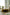 Living room with a round small coffee table, white sofa, and decorative items.