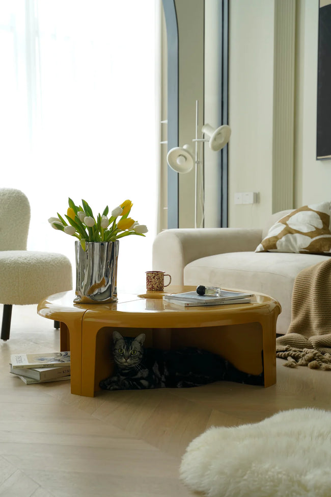 Living room with a round small coffee table, white sofa, and decorative items.