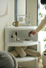 Small modular white shelf with decorative items in a bright room