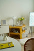 Round yellow counter side table with decorative items in a room setting