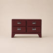 Red dresser with four drawers on a beige background