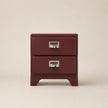 Red two-drawer nightstand with silver handles on a beige background