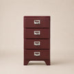 Red metal chest of drawers with silver handles on a beige background