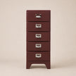 Red metal file cabinet with four drawers on a beige background