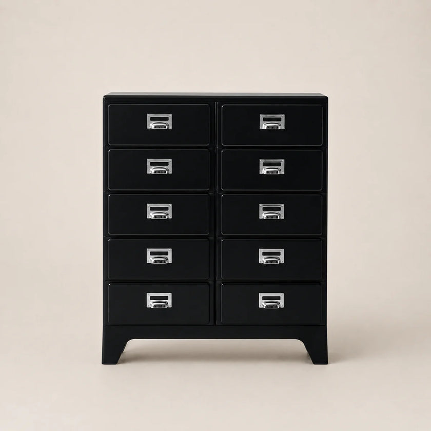 Black dresser with multiple drawers on a beige background