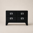 Black dresser with four drawers on a beige background