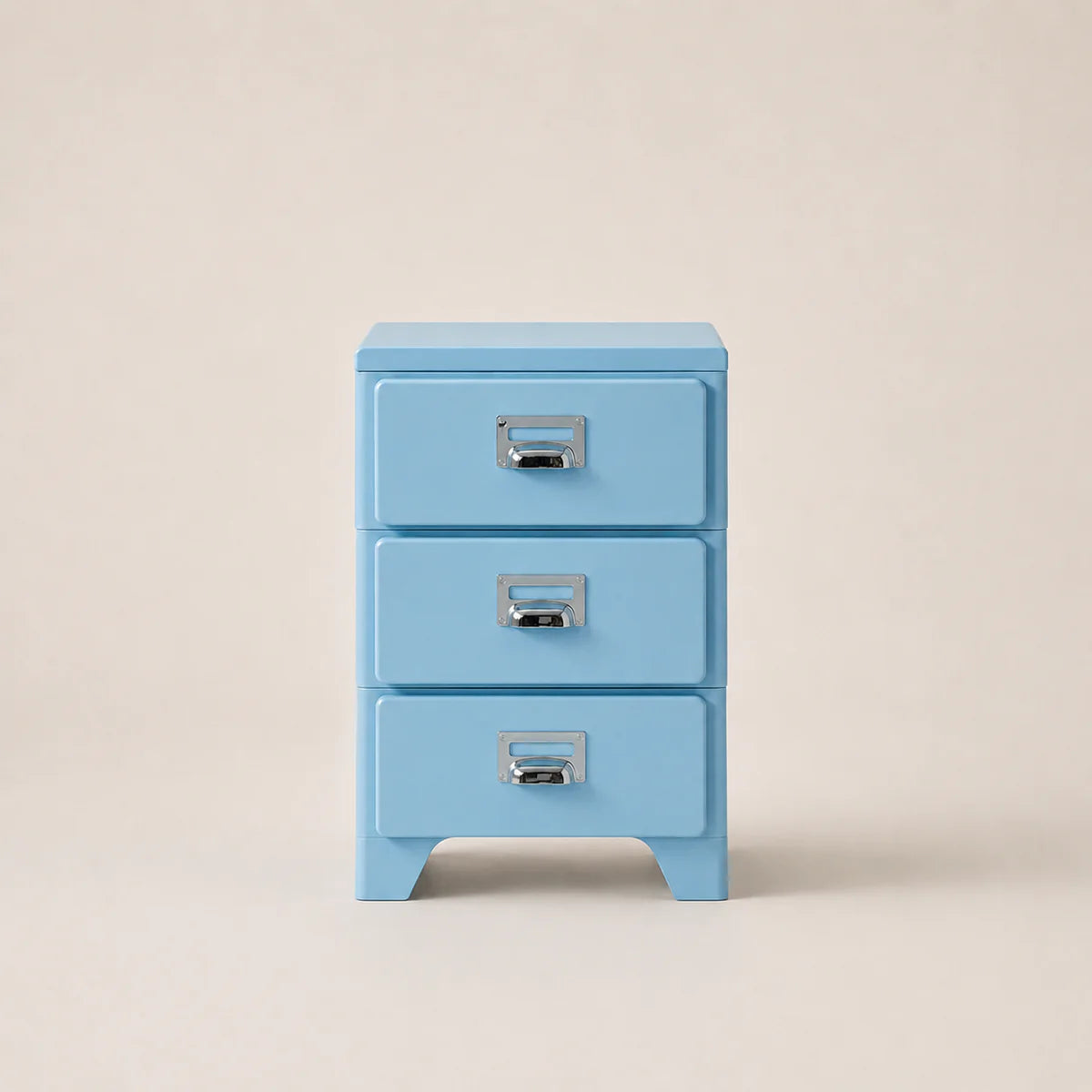 Light blue three-drawer cabinet with silver handles on a beige background