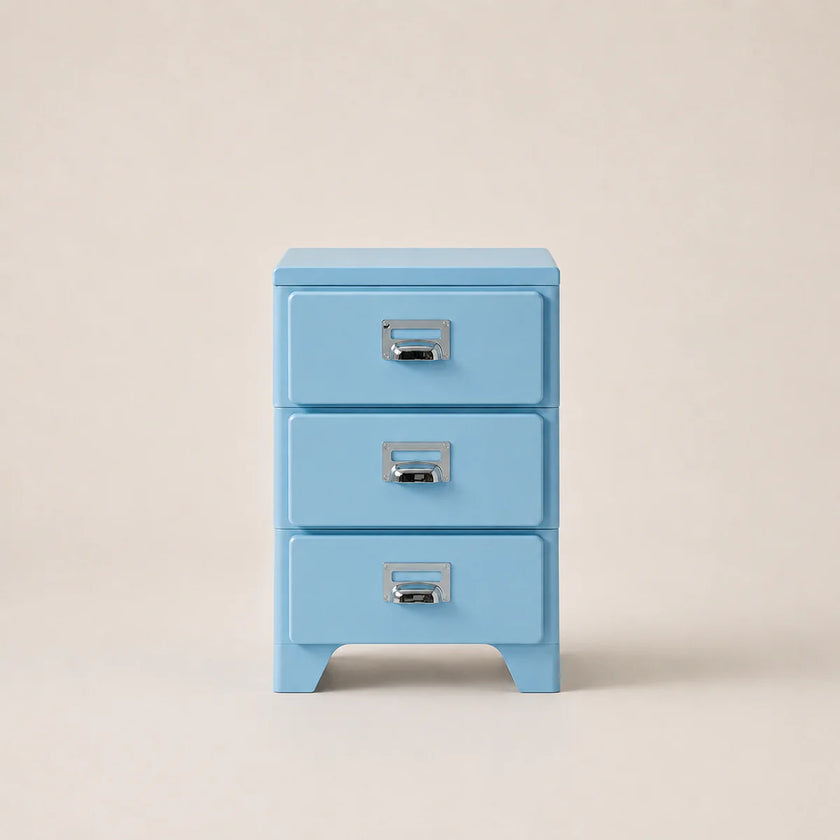 Light blue three-drawer cabinet with silver handles on a beige background