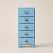 Light blue five-drawer filing cabinet with silver handles on a beige background