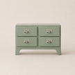 Green dresser with four drawers on a beige background