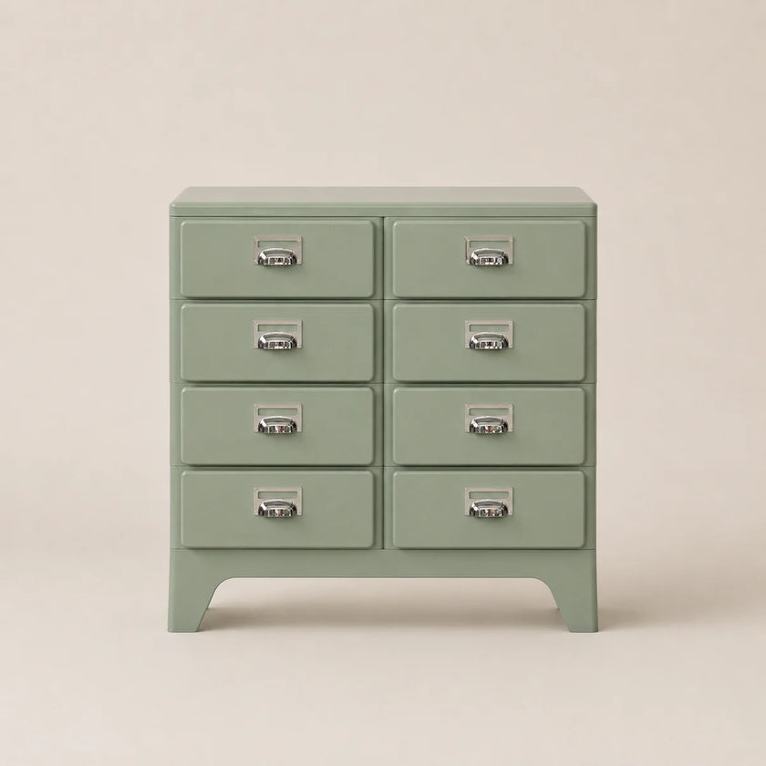 Green dresser with multiple drawers on a beige background