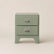 Green metal nightstand with two drawers on a beige background