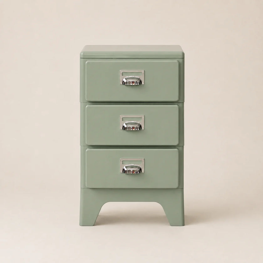 Green three-drawer nightstand with metallic handles on a beige background