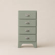 Green chest of drawers with four drawers on a beige background