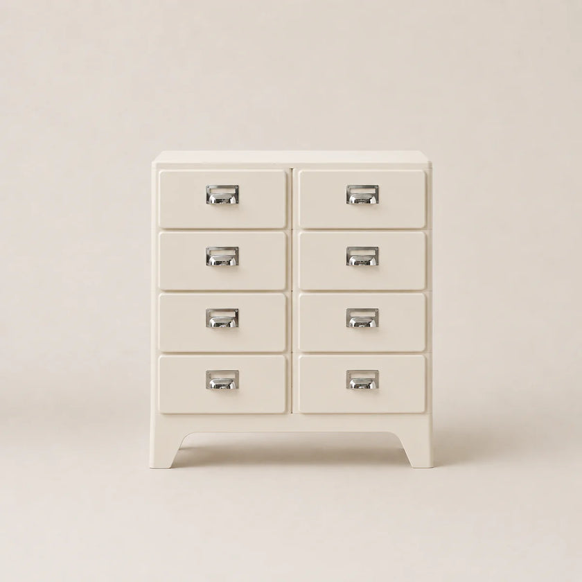 White dresser with multiple drawers on a plain background