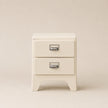 White nightstand with two drawers on a beige background