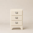 Cream-colored nightstand with three drawers on a beige background