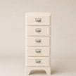 White five-drawer cabinet with silver handles on a beige background