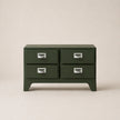 Green four-drawer chest with silver handles on a beige background