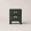 Green two-drawer nightstand with metal handles on a beige background