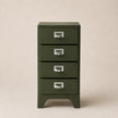 Green metal cabinet with four drawers on a beige background
