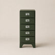 Green metal file cabinet with four drawers on a beige background