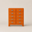 Orange dresser with multiple drawers on a beige background