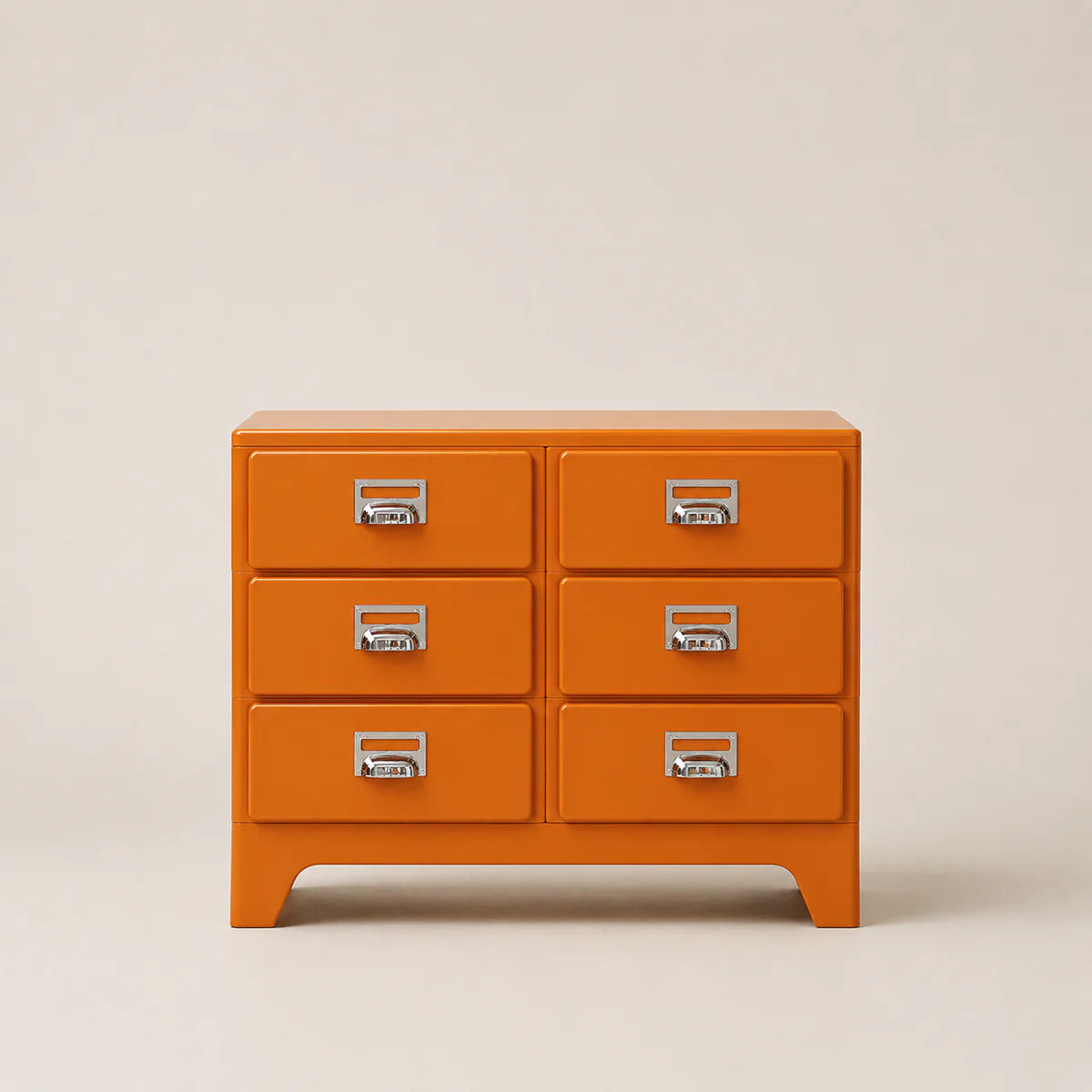 Orange dresser with silver handles on a beige background