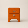 Orange two-drawer nightstand with metal handles on a beige background