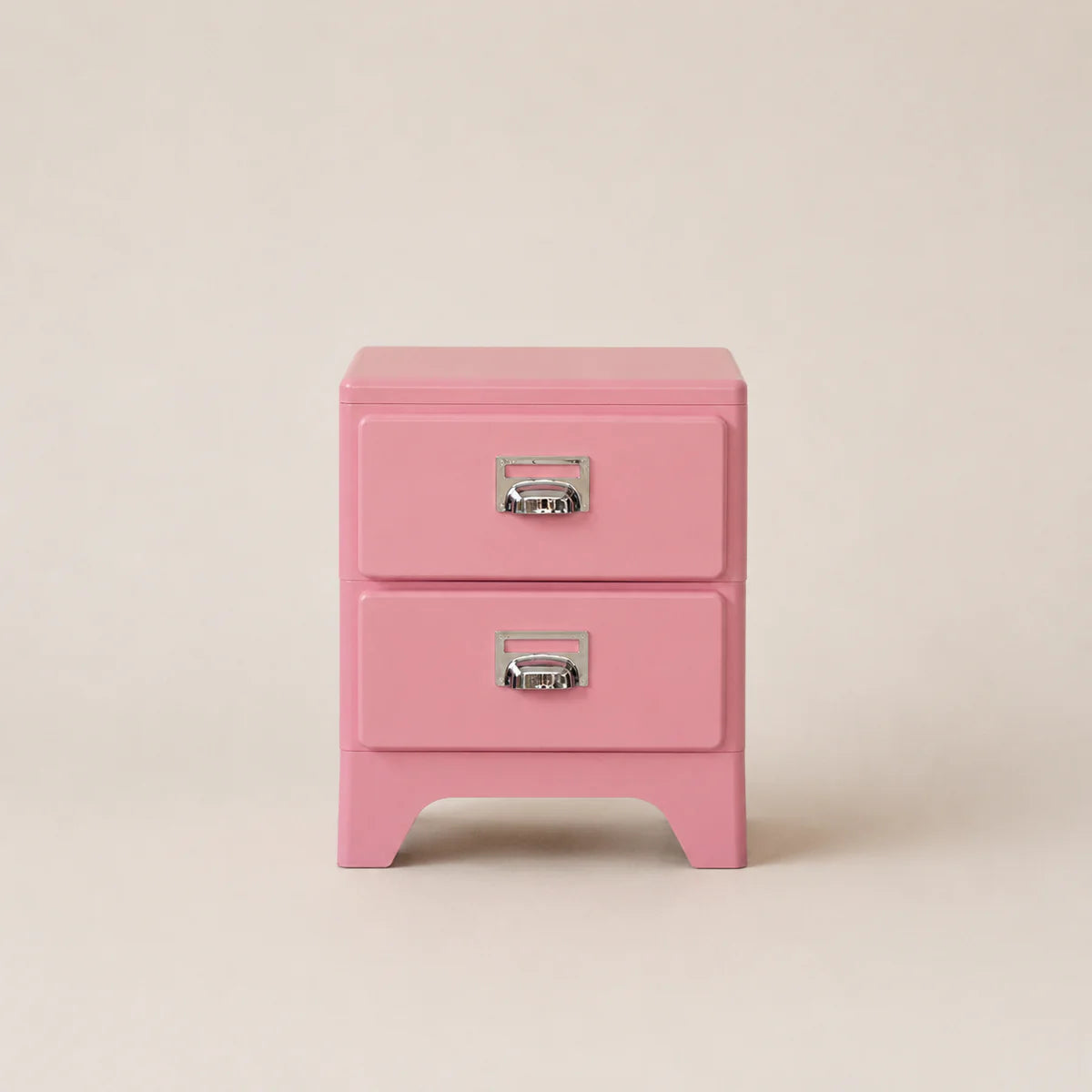 Pink two-drawer nightstand with silver handles on a beige background