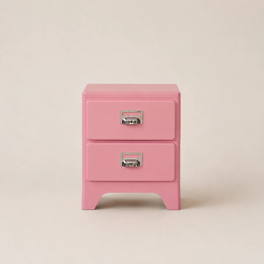 Pink two-drawer nightstand with silver handles on a beige background