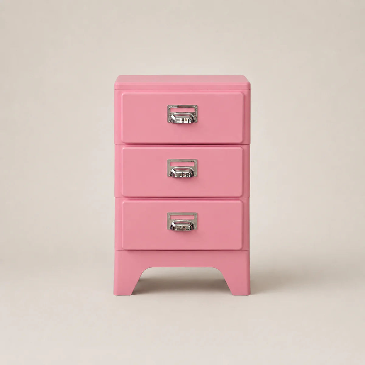 Pink three-drawer jewelry box with silver handles on a beige background