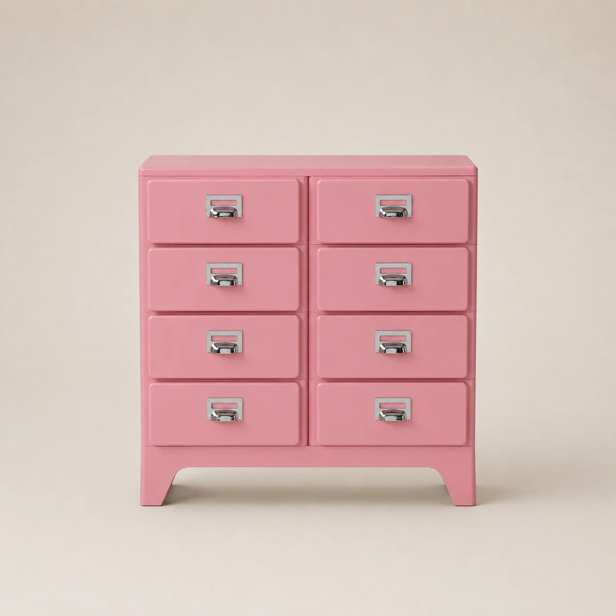 Pink dresser with multiple drawers on a beige background