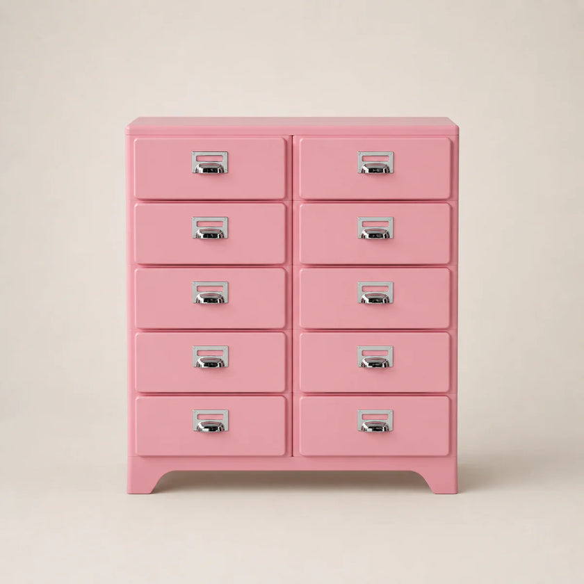 Pink dresser with multiple drawers on a beige background