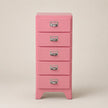Pink five-drawer chest with silver handles on a beige background
