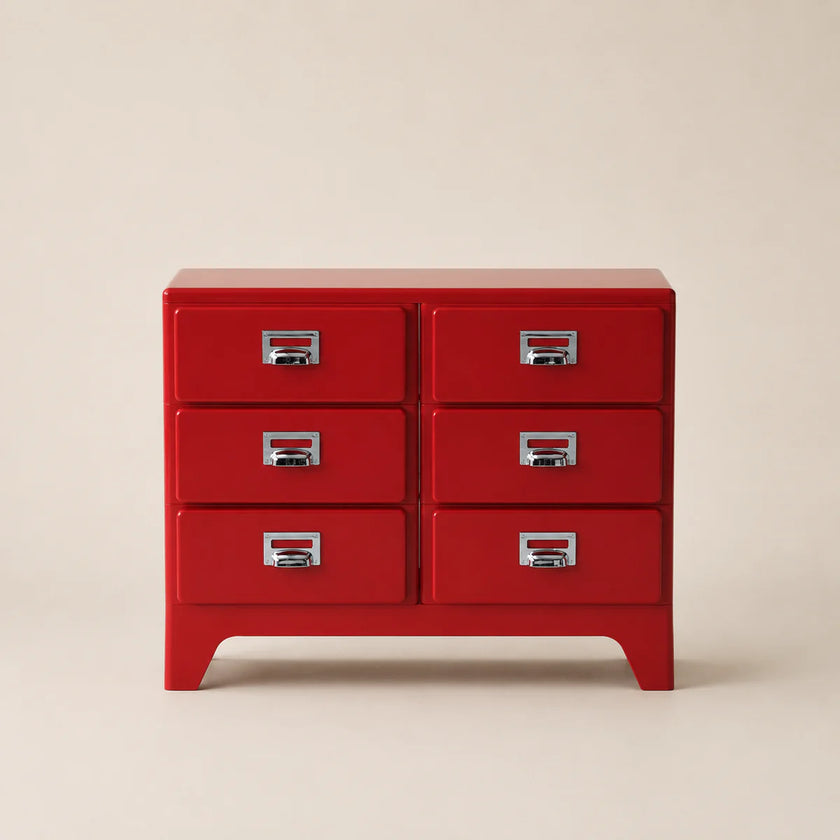 Red dresser with four drawers on a beige background
