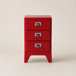 Red three-drawer cabinet on a beige background