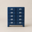 Blue metal cabinet with multiple drawers on a beige background
