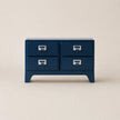 Blue dresser with four drawers on a beige background
