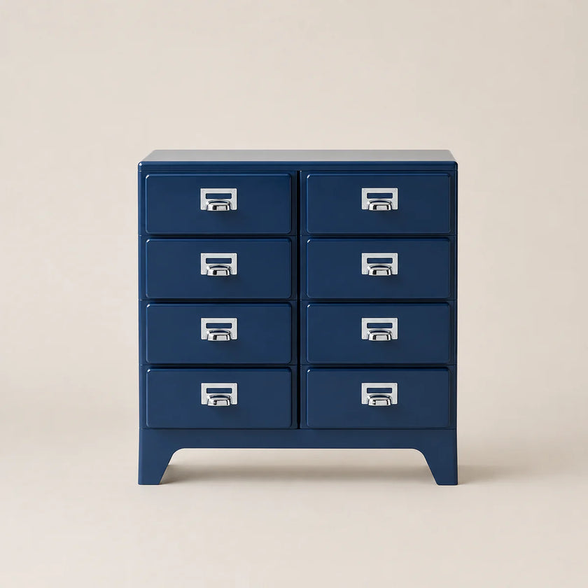 Blue dresser with multiple drawers on a beige background