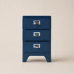 Blue three-drawer nightstand with silver handles on a beige background