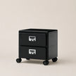 Black two-drawer filing cabinet on wheels with silver handles against a beige background