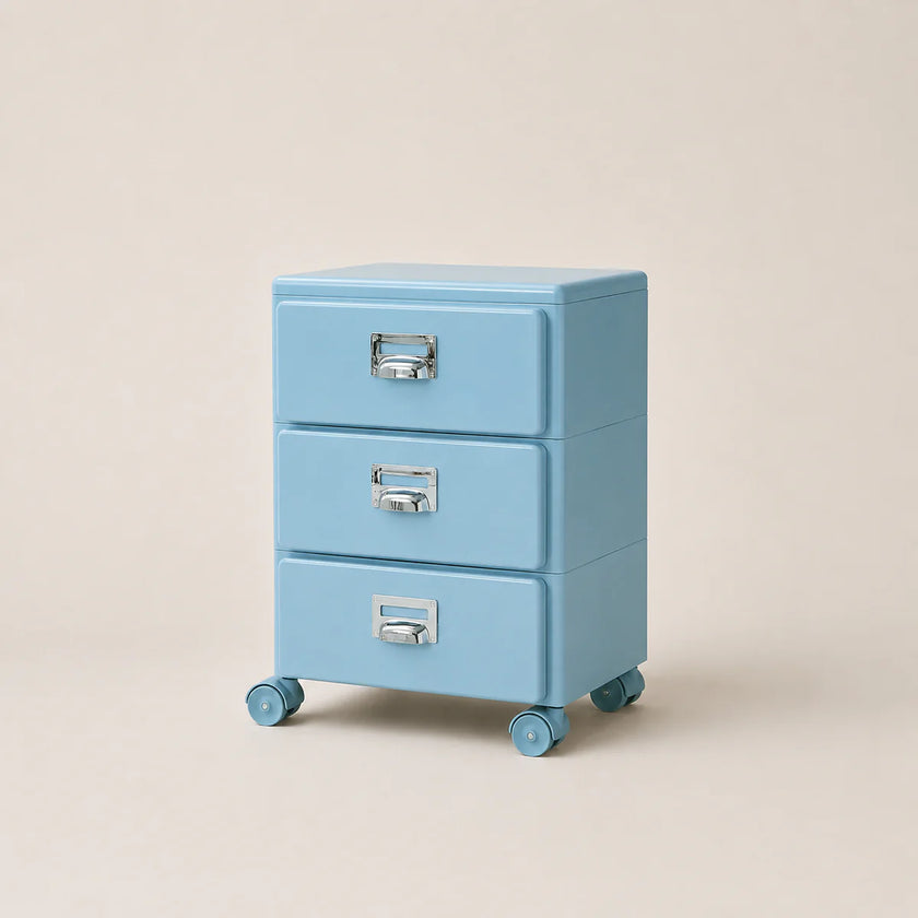 Light blue three-drawer filing cabinet on wheels with silver handles against a beige background