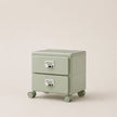Light green two-drawer filing cabinet on wheels with metallic handles against a beige background