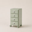 Light green metal file cabinet with four drawers on wheels against a beige background