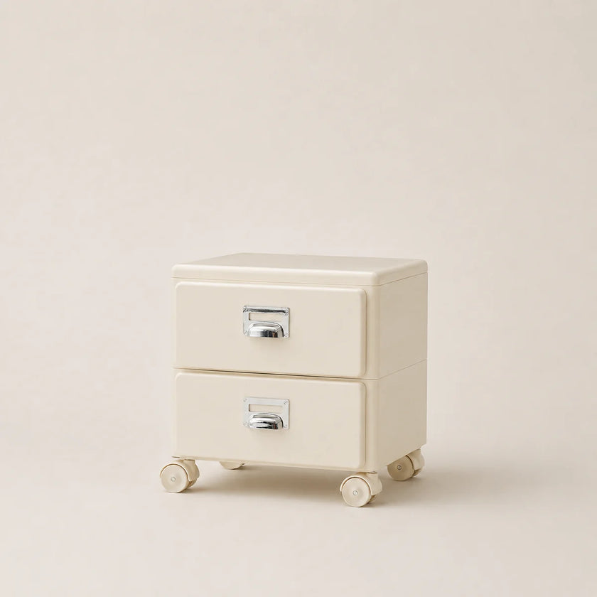 Cream-colored two-drawer nightstand with wheels on a beige background