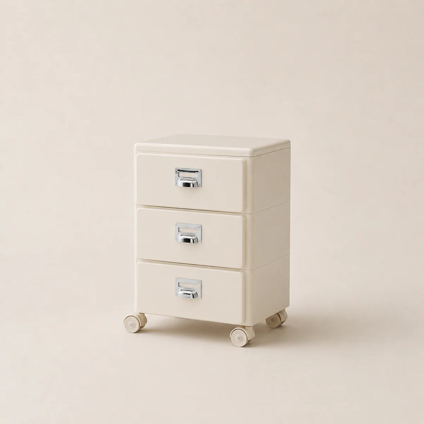 Beige three-drawer filing cabinet on wheels with metallic handles against a beige background