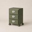 Green three-drawer filing cabinet on wheels with silver handles against a beige background