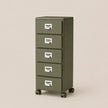 Green five-drawer filing cabinet on wheels with silver handles against a beige background